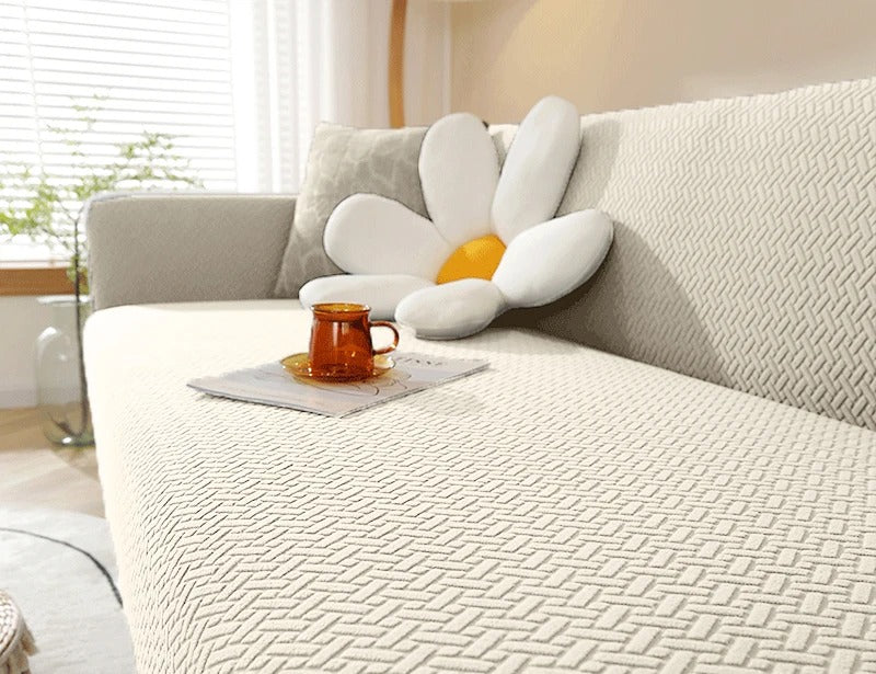 Housse de canapé jacquard tressé écru posée sur un canapé